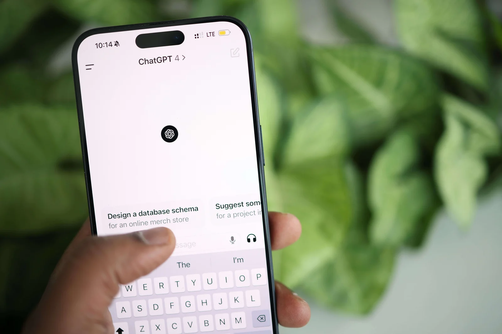 Photo of a hand holding a phone with ChatGPT open